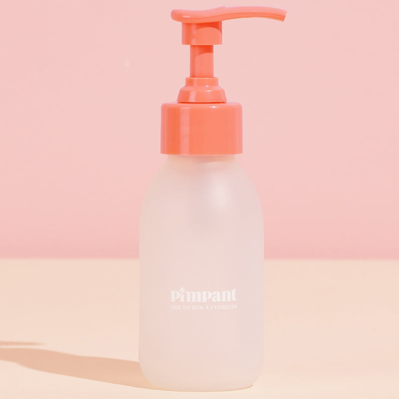 Bouteille en verre avec pompe rose (vide)